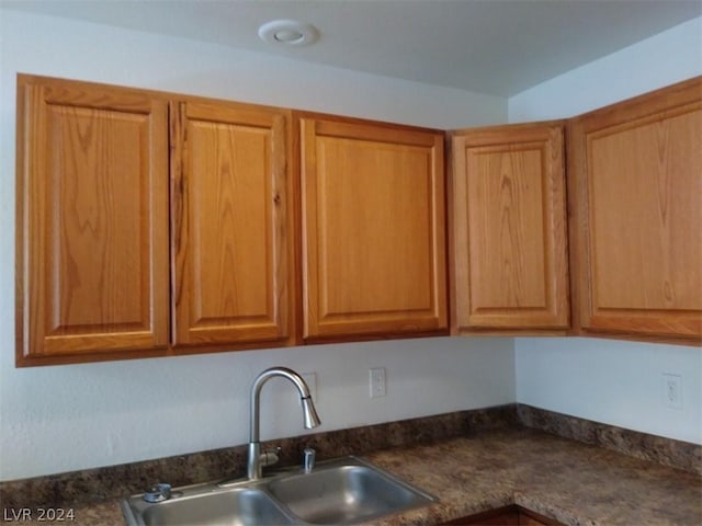 1501 Linnbaker Ln Unit 103, Las Vegas, NV 89110 - kitchen with a sink and dark countertops
