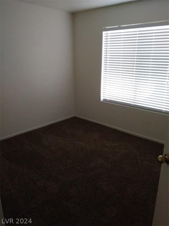 1501 Linnbaker Ln Unit 103, Las Vegas, NV 89110 - empty room with dark colored carpet and baseboards