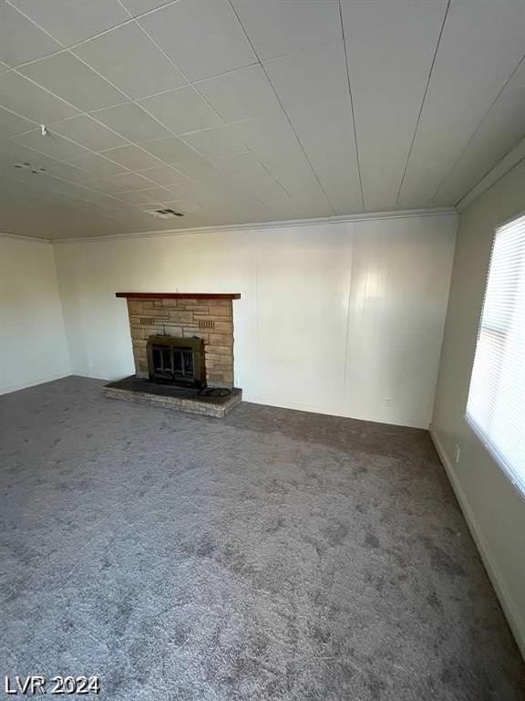 unfurnished living room with carpet floors and a fireplace