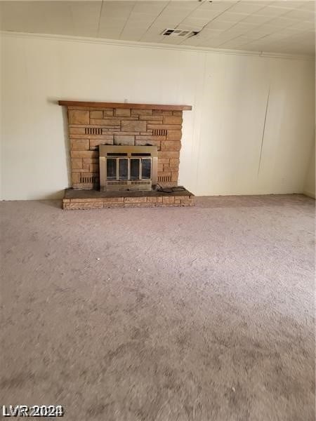 unfurnished living room with a fireplace, crown molding, and carpet floors