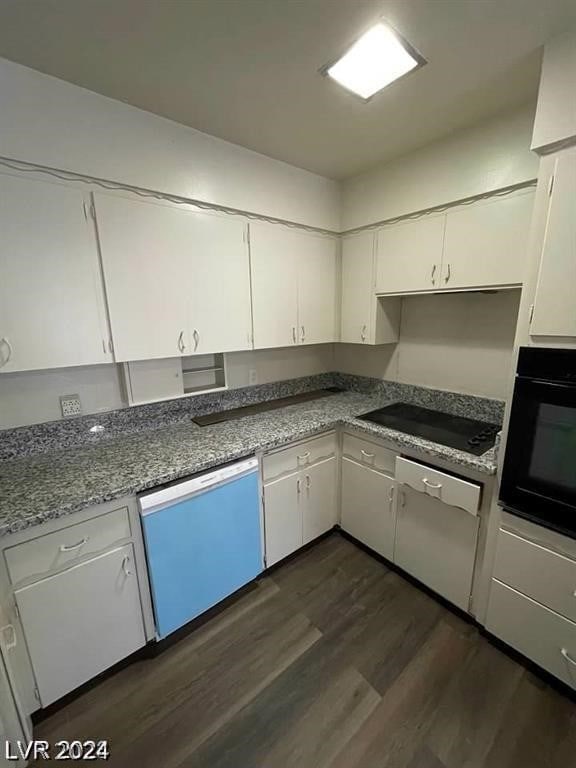 kitchen featuring dark wood-type flooring, stone counters, black appliances, and white cabinetry