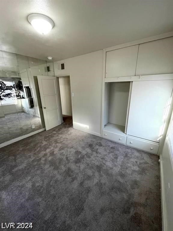 unfurnished bedroom with carpet floors and a closet