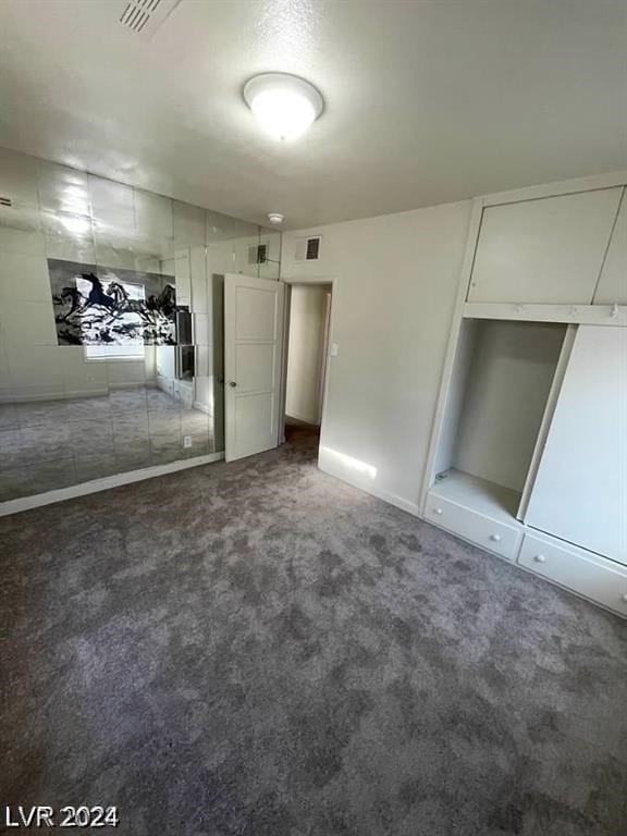 unfurnished bedroom featuring a closet and carpet floors