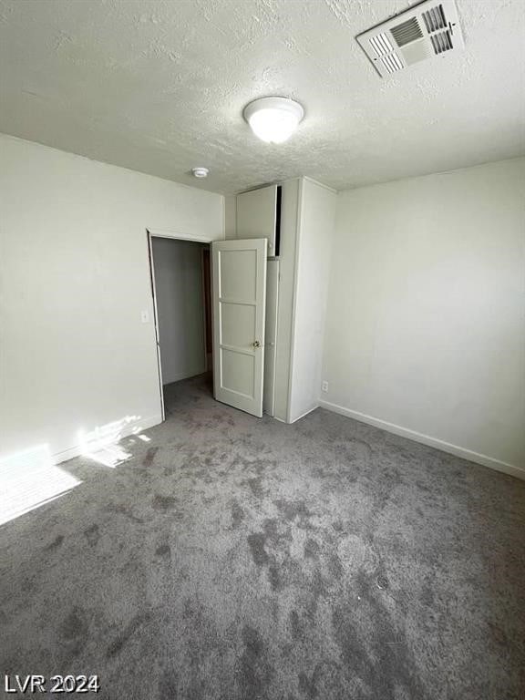 unfurnished bedroom with carpet and a textured ceiling