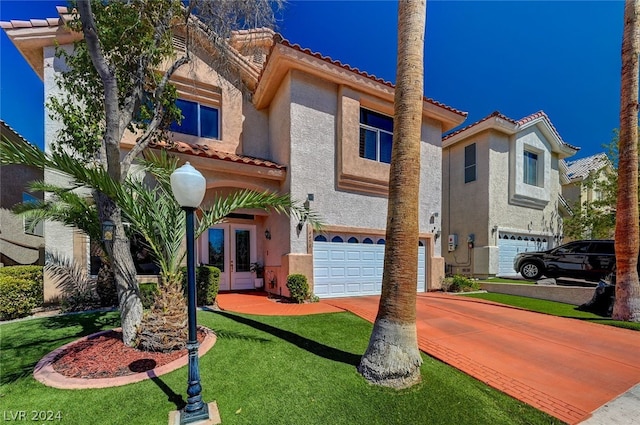 view of front of home featuring a garage and a front lawn