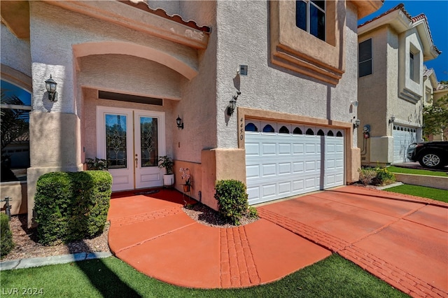 exterior space featuring a garage and french doors