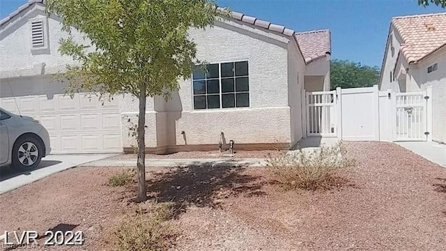 view of side of home featuring a garage