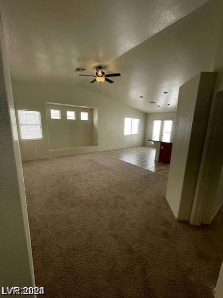 unfurnished room with vaulted ceiling, ceiling fan, and carpet