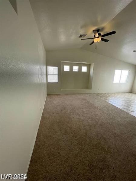 carpeted spare room with lofted ceiling and ceiling fan