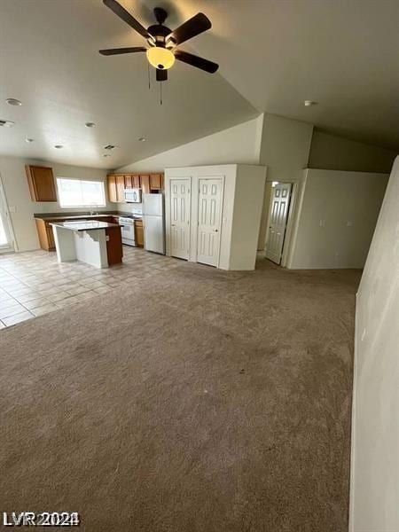 unfurnished living room featuring light carpet, lofted ceiling, and ceiling fan