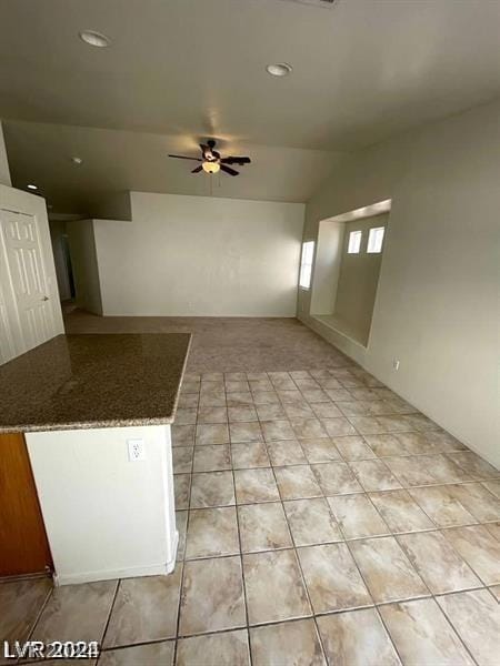 unfurnished living room with ceiling fan