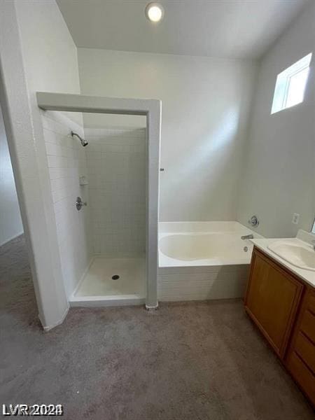 bathroom with vanity and shower with separate bathtub