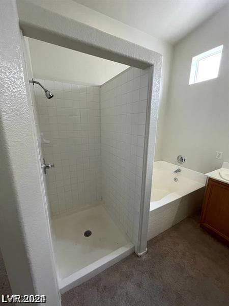 bathroom with vanity and separate shower and tub