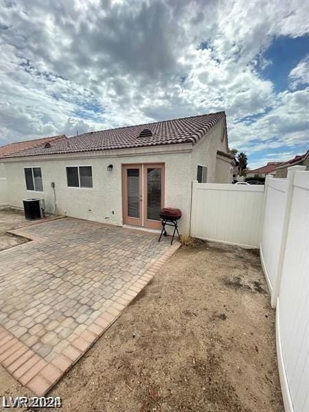 rear view of house with french doors, a patio, and central air condition unit