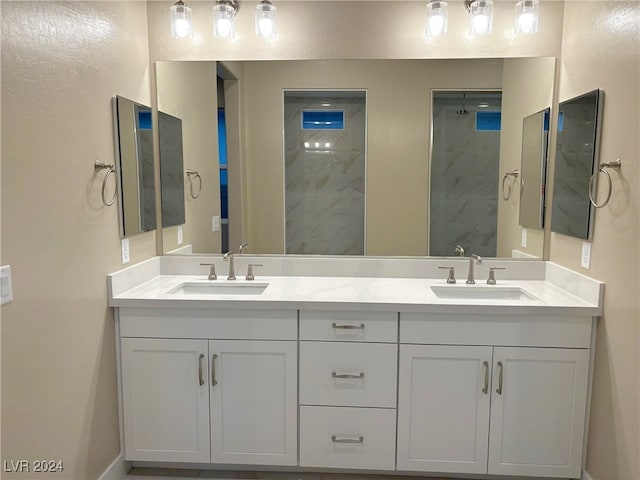 bathroom with vanity and a tile shower