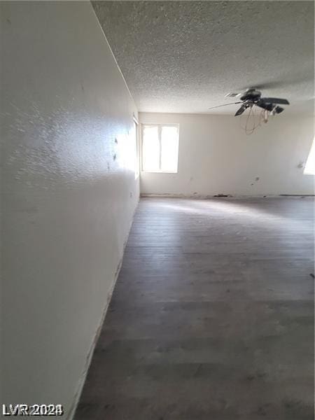 spare room featuring ceiling fan and a textured ceiling