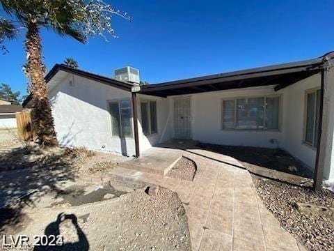 view of front of property featuring a patio and cooling unit