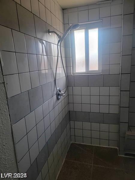 bathroom with a tile shower