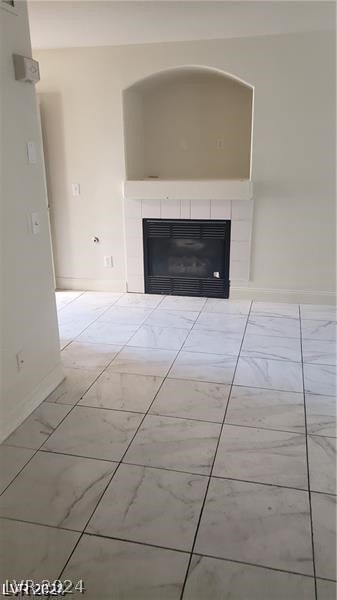 interior space featuring a fireplace and light tile patterned floors