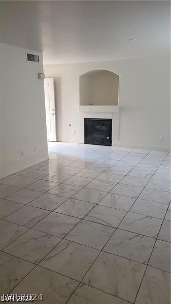 unfurnished living room featuring light tile patterned flooring