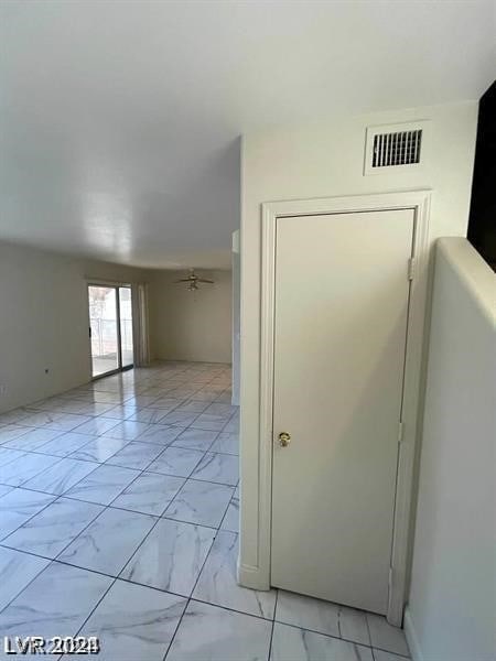 unfurnished room featuring ceiling fan and light tile patterned floors