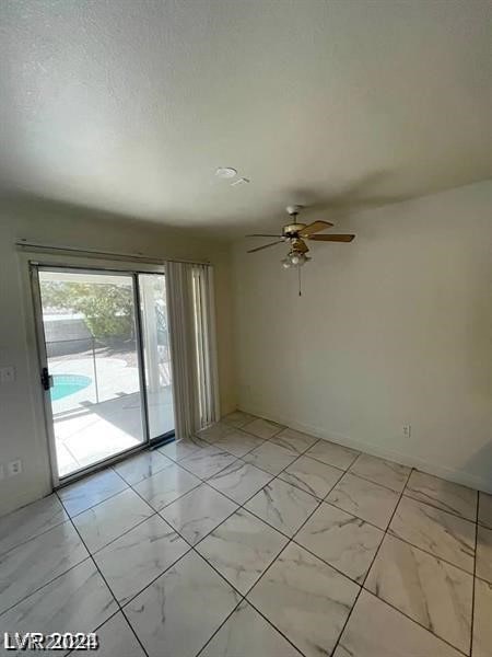 unfurnished room featuring light tile patterned floors and ceiling fan