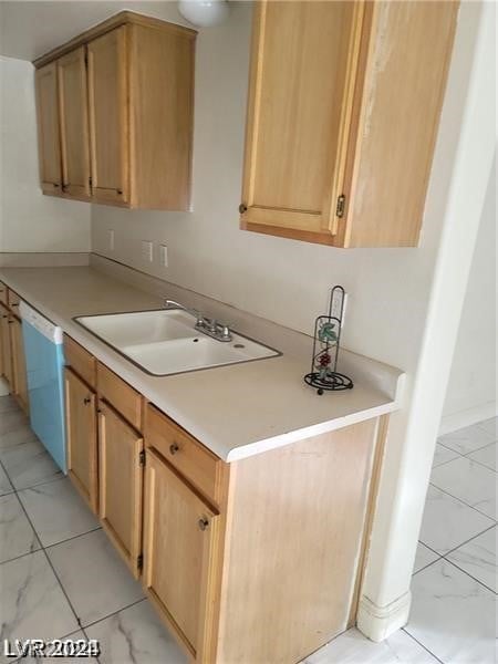 kitchen featuring light tile patterned flooring, sink, white dishwasher, and light brown cabinets