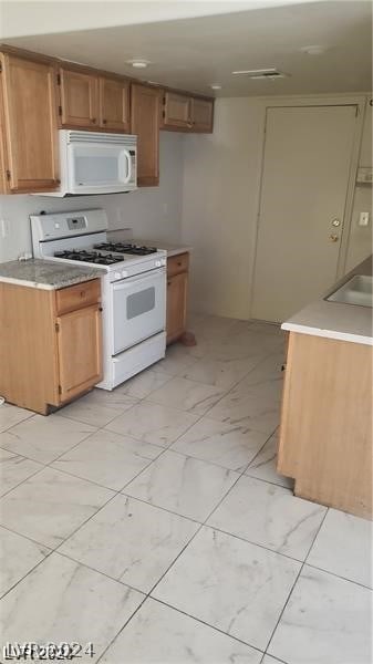 kitchen featuring white appliances and light tile patterned floors