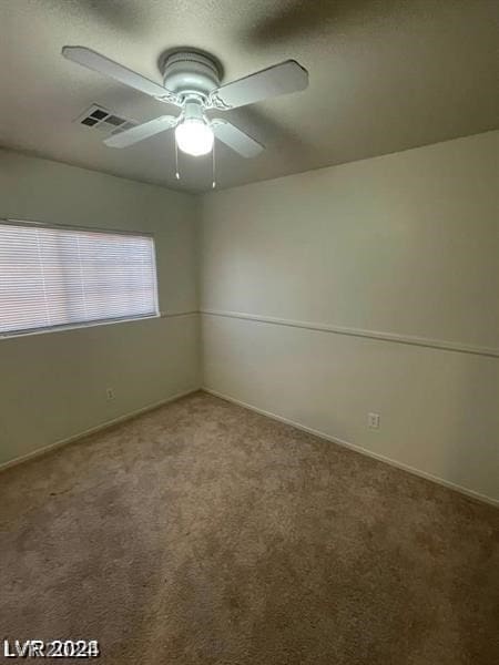 empty room with carpet flooring and ceiling fan