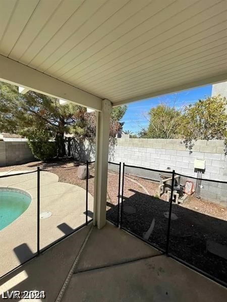 view of patio / terrace with a fenced in pool