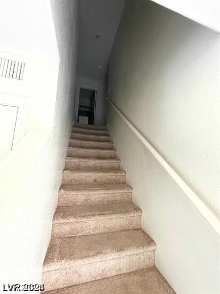 stairs featuring carpet floors