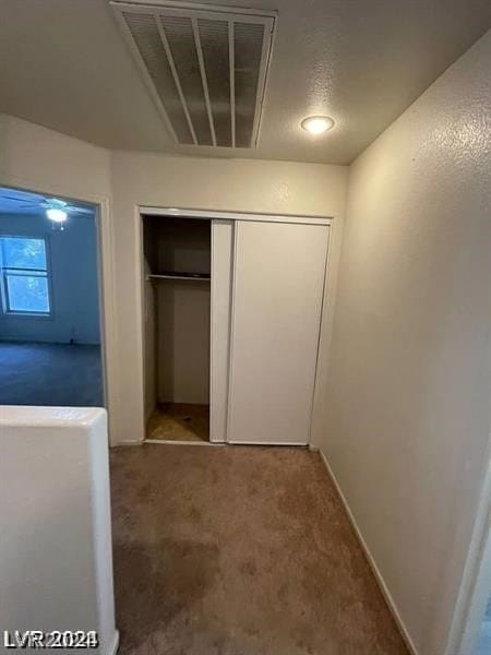 unfurnished bedroom featuring carpet and a closet