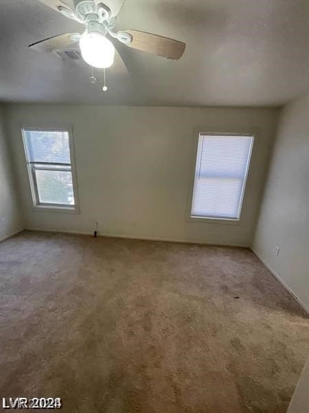 empty room with carpet and ceiling fan