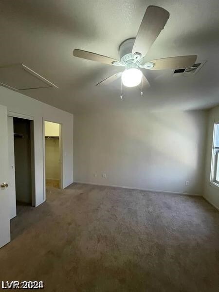 unfurnished bedroom featuring a closet, carpet flooring, and ceiling fan