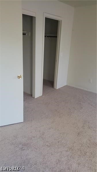 unfurnished bedroom featuring light carpet