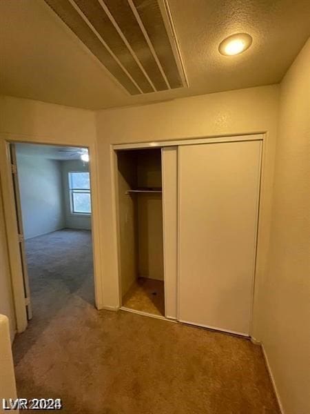 unfurnished bedroom featuring carpet and a closet