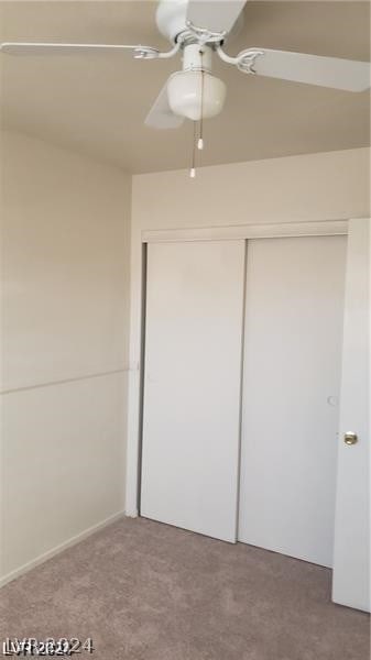 unfurnished bedroom with carpet flooring, a closet, and ceiling fan