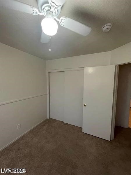 unfurnished bedroom with a closet, carpet floors, and ceiling fan