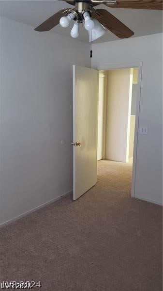 empty room with ceiling fan and light colored carpet