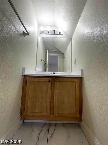 bathroom with lofted ceiling