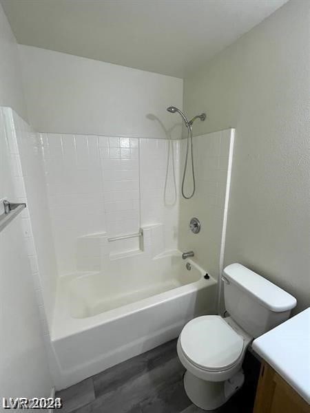 full bathroom featuring vanity, toilet,  shower combination, and hardwood / wood-style floors