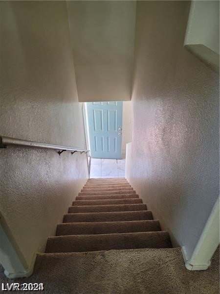 stairs with tile patterned floors