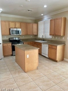 kitchen with light tile patterned floors, a kitchen island, appliances with stainless steel finishes, sink, and ornamental molding