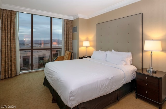 bedroom with floor to ceiling windows and ornamental molding