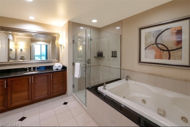 bathroom featuring shower with separate bathtub, tile patterned floors, and vanity