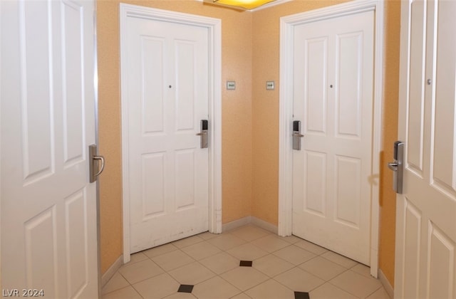 doorway featuring light tile patterned flooring