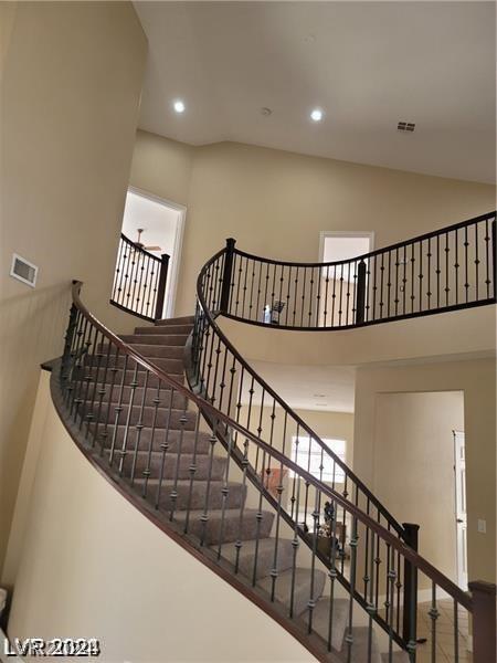 staircase featuring a high ceiling