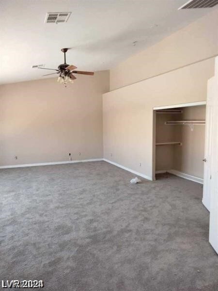 unfurnished bedroom with ceiling fan, carpet flooring, and a closet