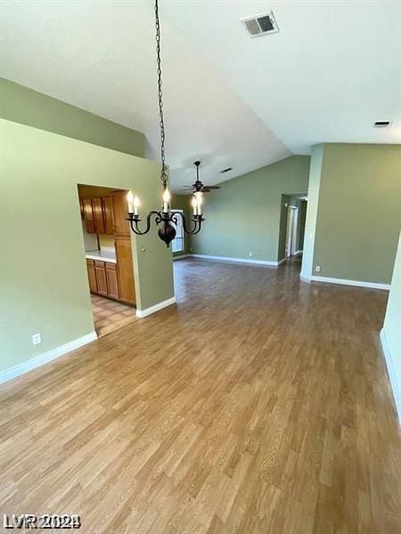 unfurnished living room featuring visible vents, light wood-type flooring, and baseboards