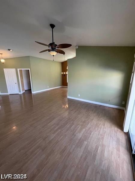 unfurnished room with dark wood-style floors, a ceiling fan, and baseboards